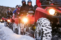 group-people-driving-quad-bikes-snowy-road-2